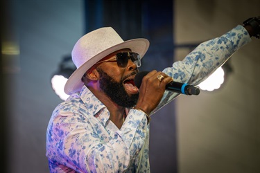 This is a photo of an artist performing at the 2024 Kissimmee Juneteenth Festival.
