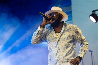This is a photo of an artist performing at the 2024 Kissimmee Juneteenth Festival.