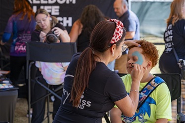 Kid getting face painted at Kowtown Festival