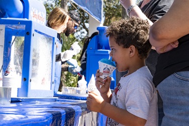 Kid getting snow cone at Kowtown Festival 