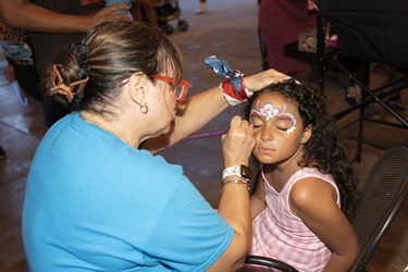 Girl getting face painted at Monumental 4th of July in Kissimmee. 