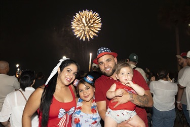 Family watching fireworks at Monumental 4th of July in Kissimmee.